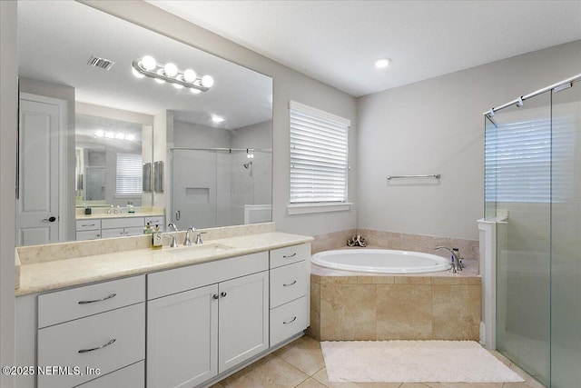 bathroom with a garden tub, visible vents, a shower stall, vanity, and tile patterned flooring