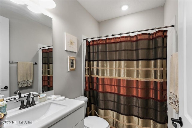 bathroom with toilet and vanity