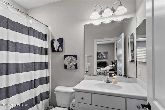 bathroom featuring connected bathroom, vanity, and toilet