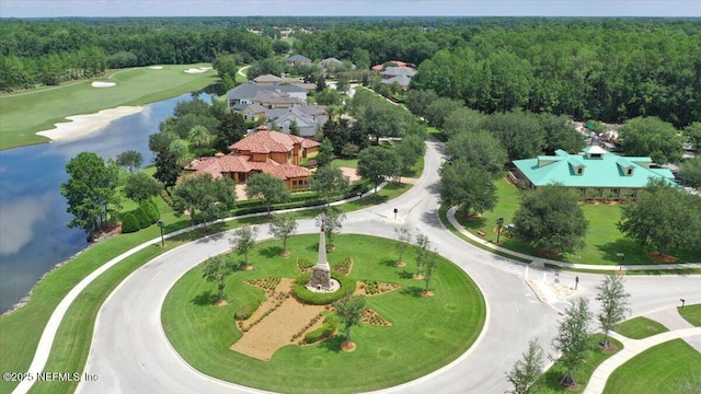 drone / aerial view featuring a water view and a wooded view