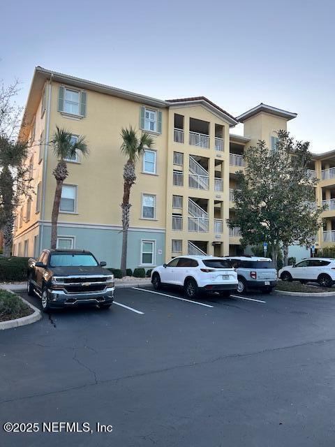 view of property featuring uncovered parking