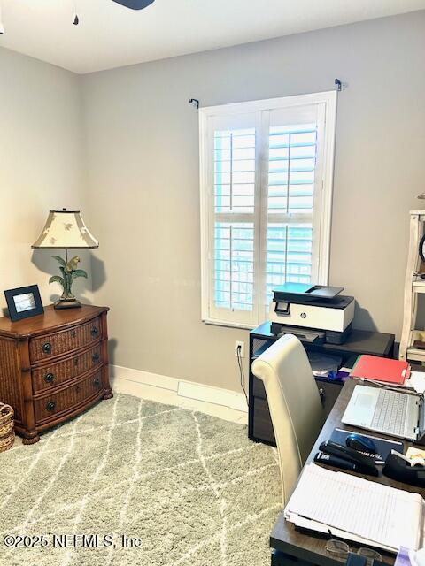 home office with ceiling fan and baseboards