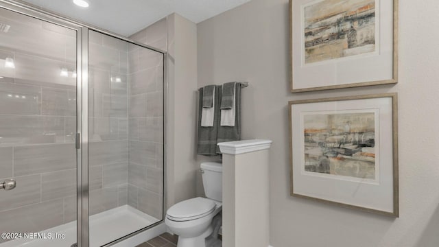 bathroom featuring a shower stall and toilet