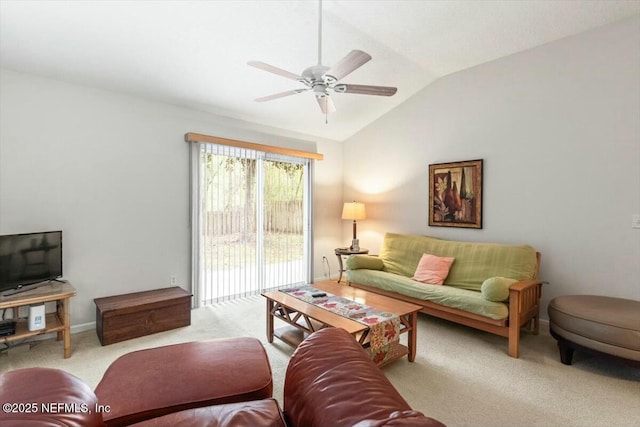 living room with a ceiling fan, light colored carpet, vaulted ceiling, and baseboards