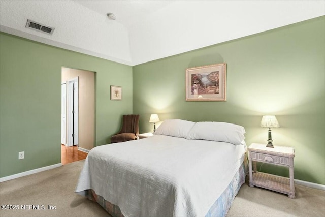 bedroom featuring light colored carpet, visible vents, and baseboards