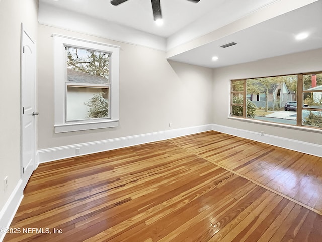 spare room with ceiling fan, recessed lighting, wood finished floors, and baseboards