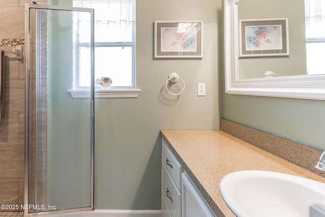 bathroom featuring a shower stall and vanity