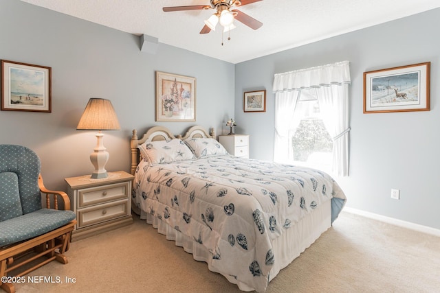 bedroom featuring baseboards, ceiling fan, and light colored carpet