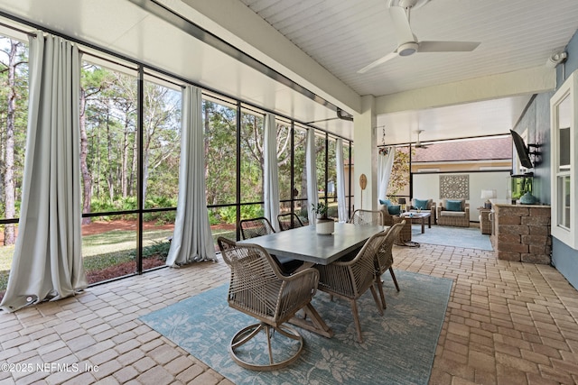 sunroom with a wealth of natural light and ceiling fan