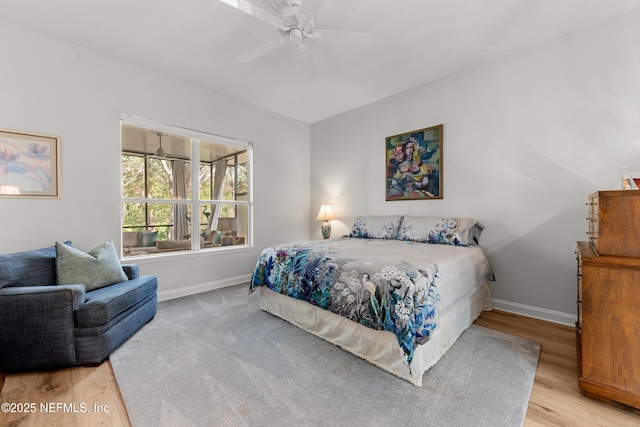 bedroom featuring a ceiling fan, baseboards, and wood finished floors