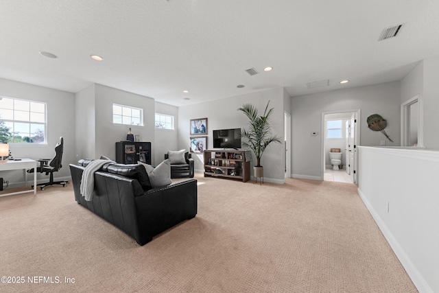 living area featuring recessed lighting, light carpet, visible vents, and baseboards