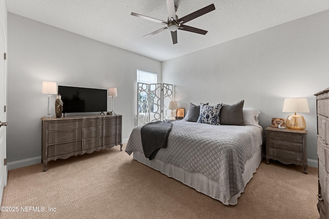 bedroom with light carpet, ceiling fan, a textured ceiling, and baseboards