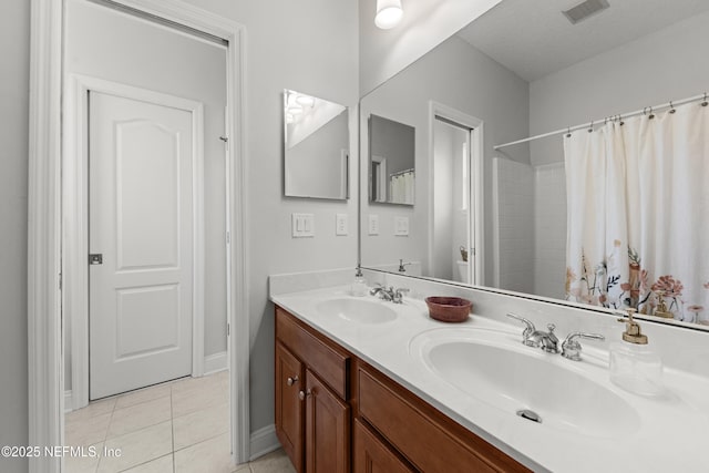 full bath with double vanity, a sink, visible vents, and tile patterned floors