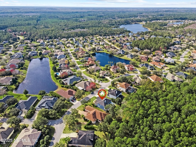 aerial view with a residential view, a water view, and a forest view