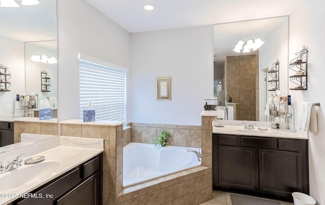 bathroom featuring two vanities, a sink, a garden tub, and walk in shower