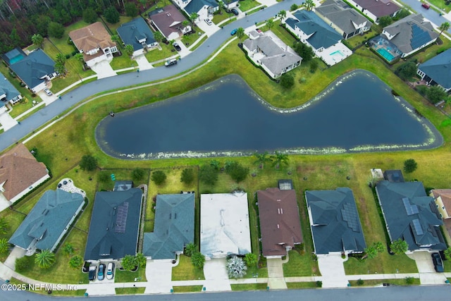 drone / aerial view featuring a residential view and a water view