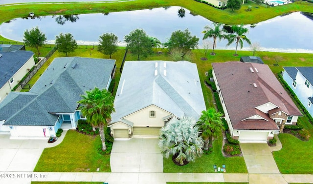 drone / aerial view with a residential view and a water view