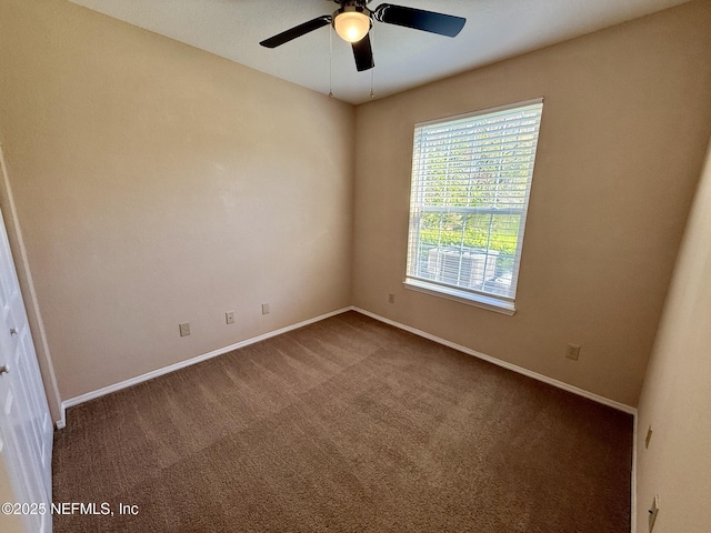 unfurnished room with carpet, baseboards, and a ceiling fan