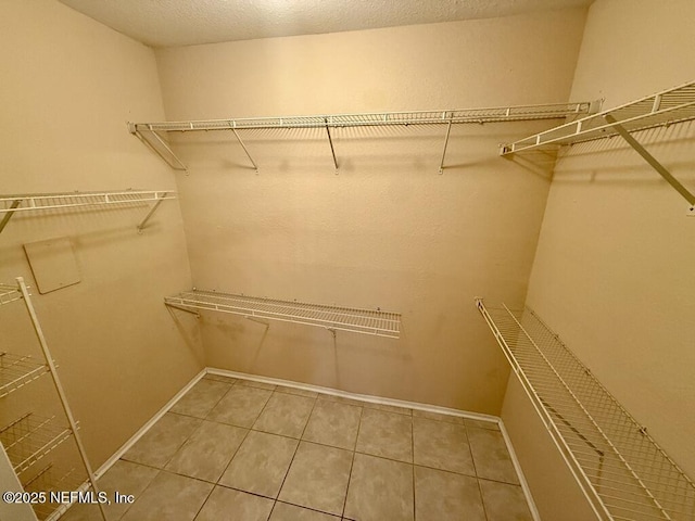 walk in closet featuring tile patterned flooring