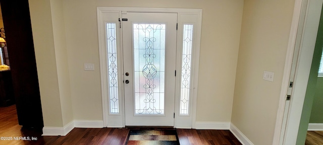 entrance foyer featuring dark wood-type flooring and baseboards