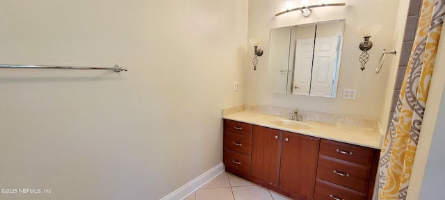 bathroom with tile patterned flooring, vanity, and baseboards