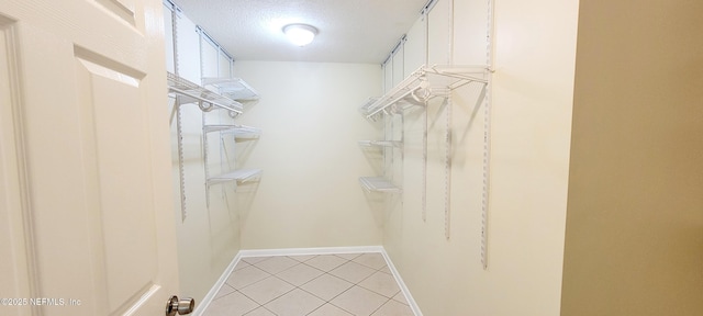 spacious closet with light tile patterned flooring