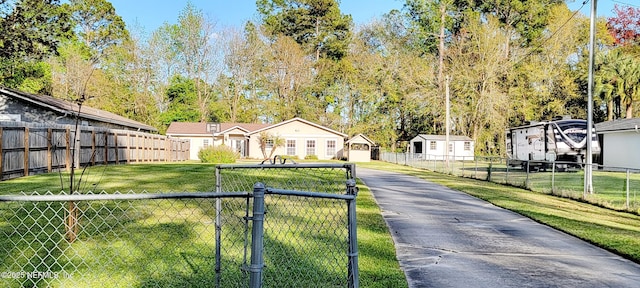 view of front facade featuring a front lawn, fence, and a residential view