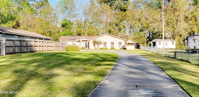 view of front of home with a front yard, fence, and a residential view