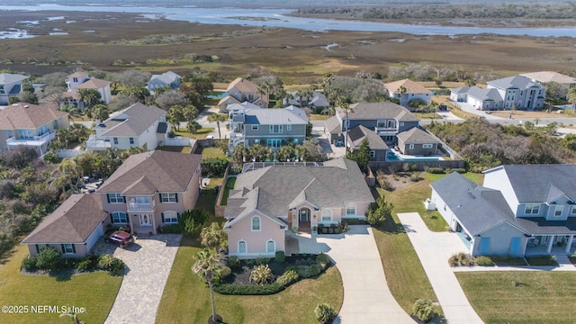 drone / aerial view featuring a residential view and a water view