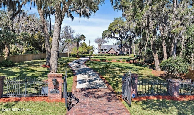 surrounding community featuring a fenced front yard and a lawn