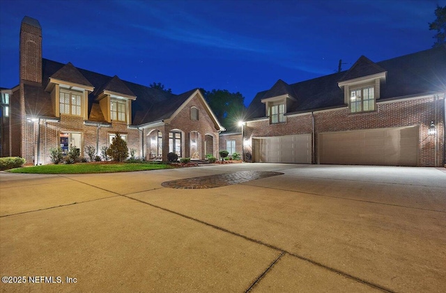 view of front of house with concrete driveway and brick siding