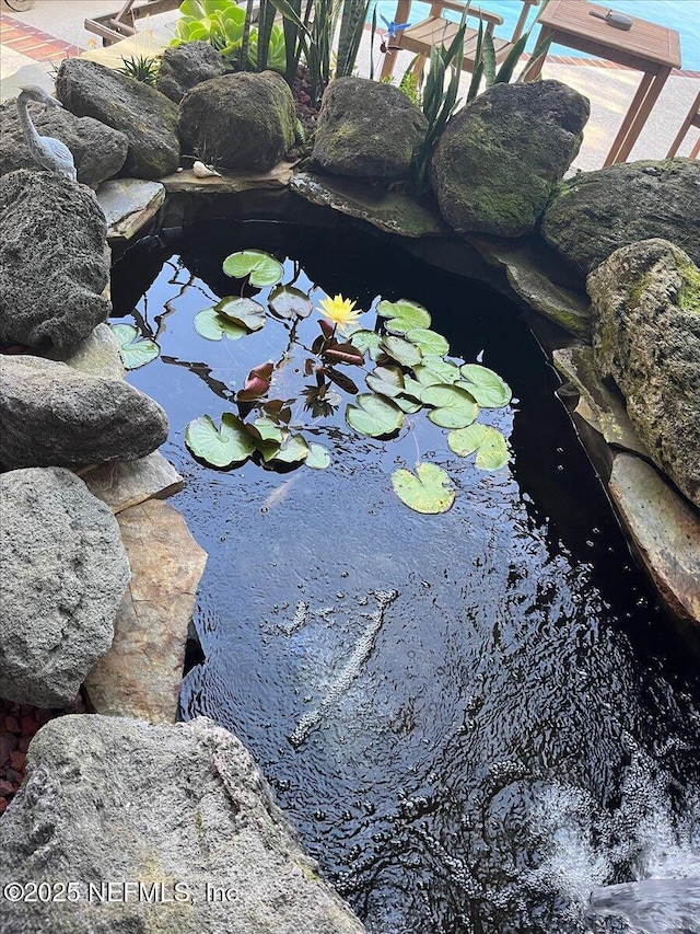 exterior details with a small pond