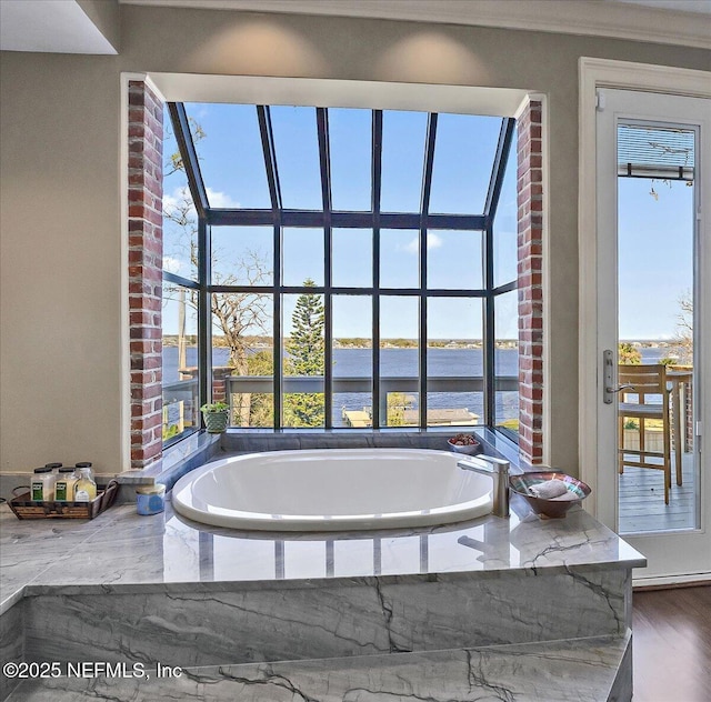 full bathroom with a water view and a bath