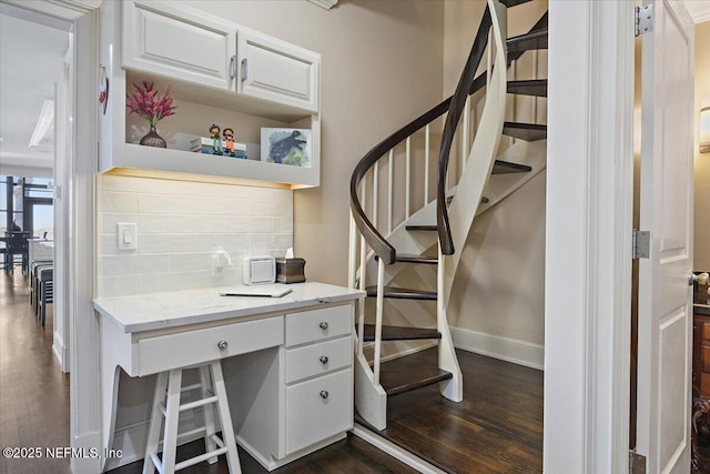 interior space featuring wood finished floors and baseboards