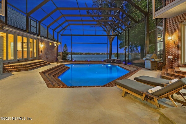 outdoor pool featuring a patio area, a lanai, a grill, and a water view