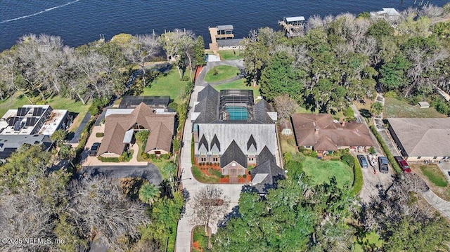 birds eye view of property with a water view