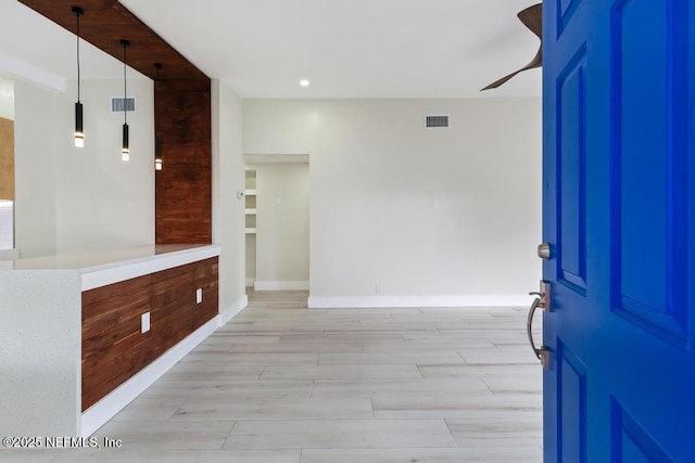 entryway with light wood-type flooring, visible vents, baseboards, and recessed lighting