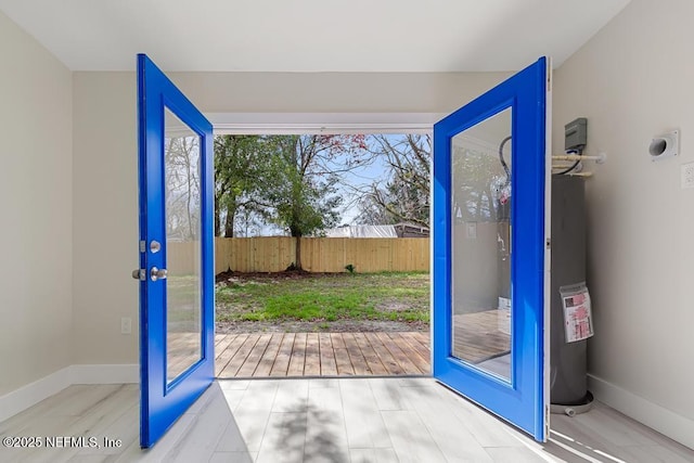 doorway to outside with french doors and baseboards