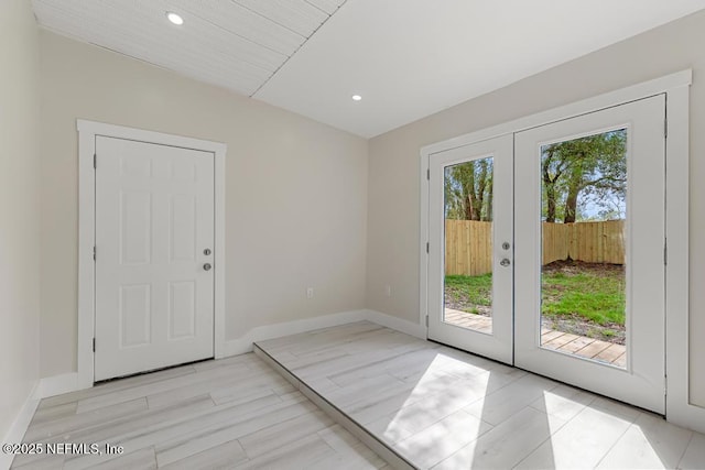 doorway featuring light wood-type flooring, french doors, recessed lighting, and baseboards