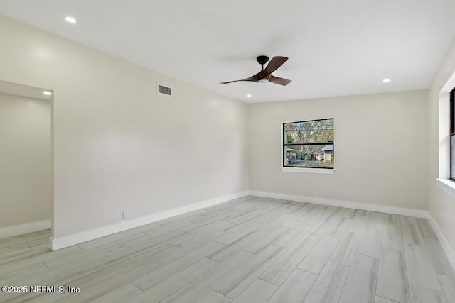 spare room with light wood finished floors, recessed lighting, visible vents, a ceiling fan, and baseboards