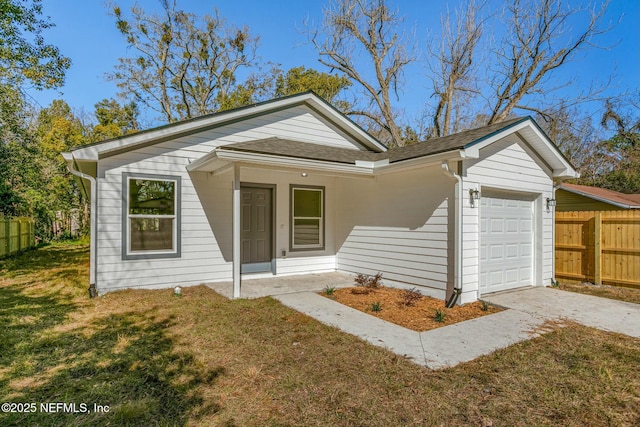 bungalow-style home with a garage, a shingled roof, fence, driveway, and a front lawn