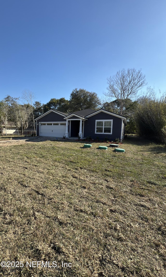 view of front of property featuring a garage and a front yard