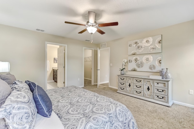 bedroom with baseboards, a spacious closet, visible vents, and light colored carpet