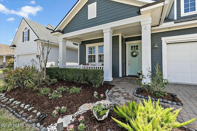 view of front of property with a porch and an attached garage