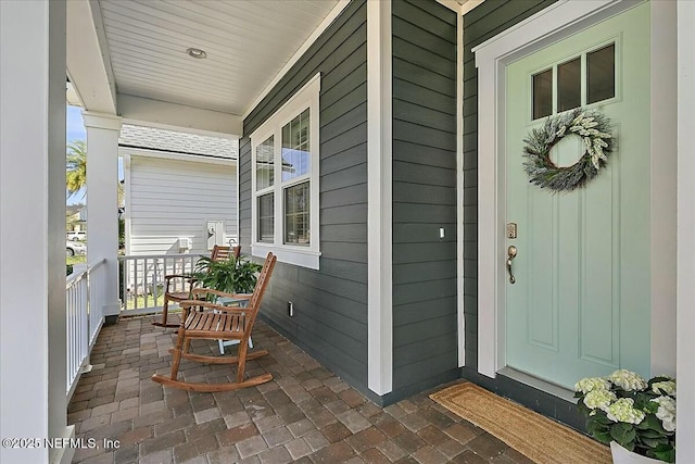 doorway to property featuring covered porch