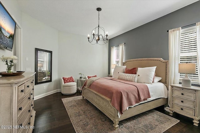 bedroom with dark wood-type flooring, a chandelier, and baseboards