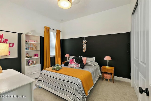 bedroom featuring light colored carpet and baseboards