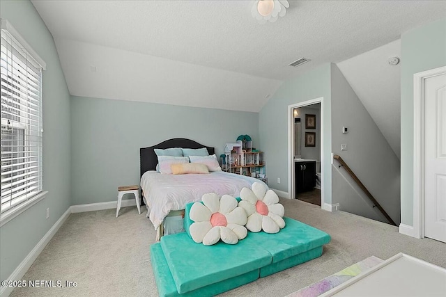 bedroom featuring a textured ceiling, light colored carpet, visible vents, and baseboards