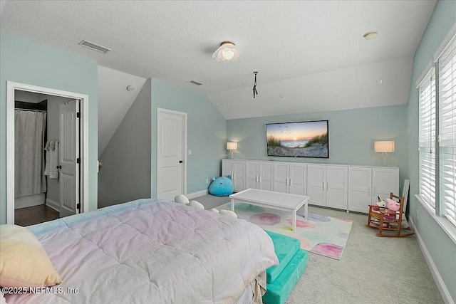 carpeted bedroom with lofted ceiling, visible vents, a textured ceiling, and baseboards