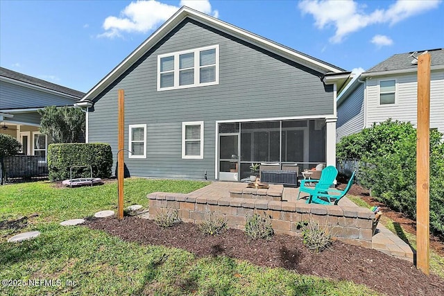 back of property featuring an outdoor fire pit, fence, a sunroom, a yard, and a patio area